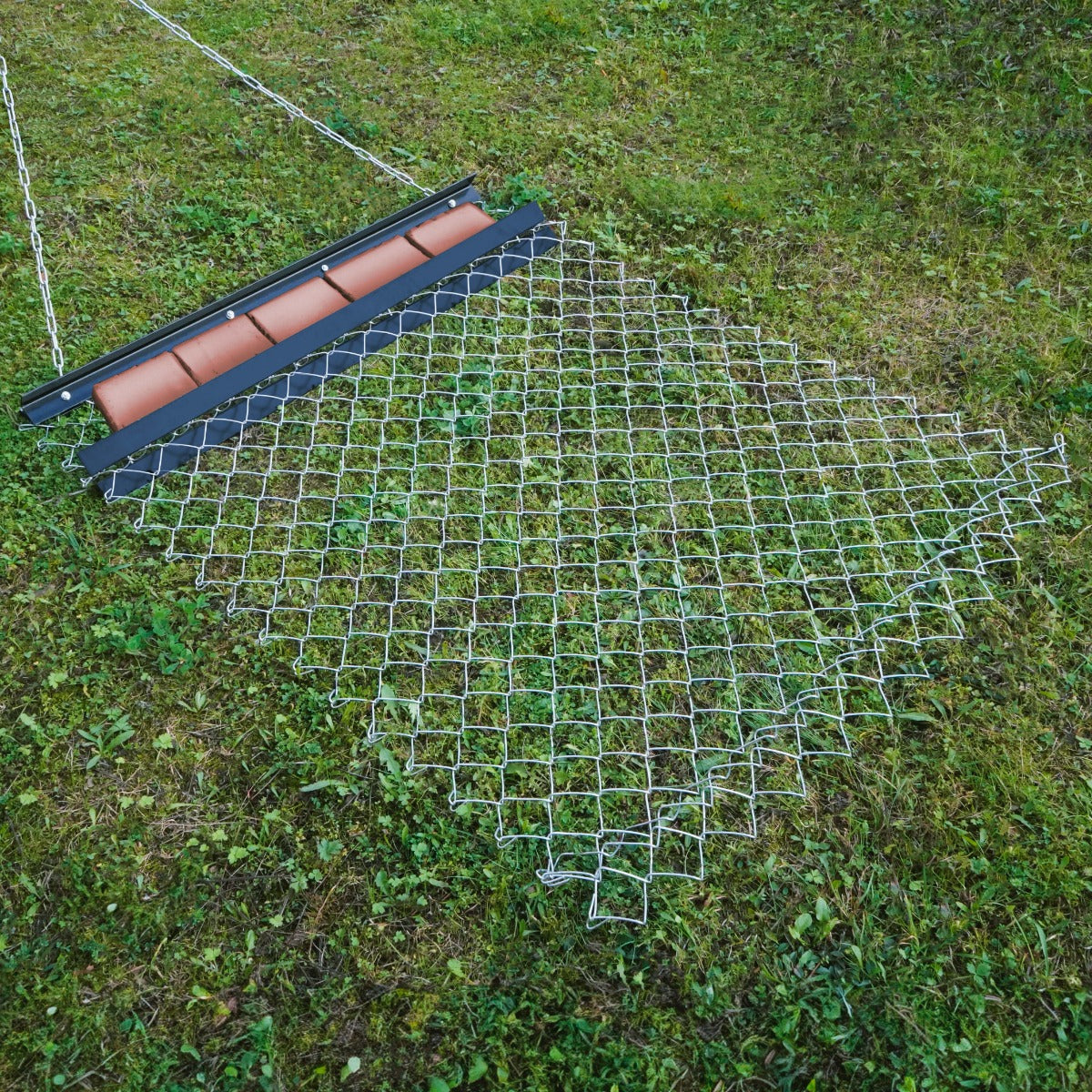 Durable chain drag harrow measuring 1.5m x 1.2m, featuring a metal grid design with a sturdy roller for effective soil leveling
