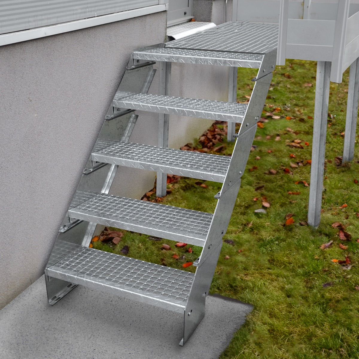Galvanised staircase with nine adjustable sections, featuring a textured surface for grip, set against a grassy backdrop