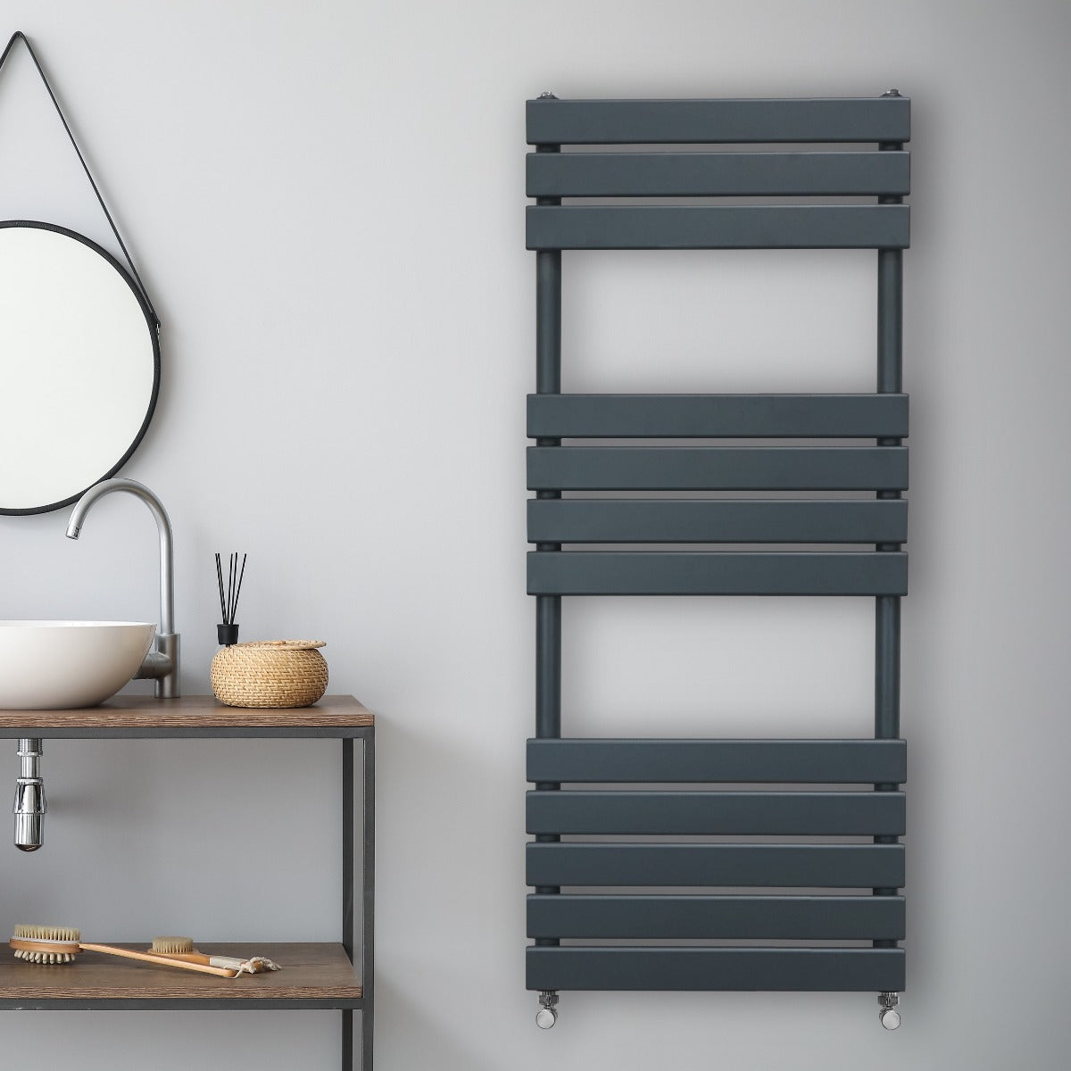 Sleek anthracite grey flat panel towel radiator mounted on a wall, featuring horizontal slats and a modern design in a stylish bathroom setting