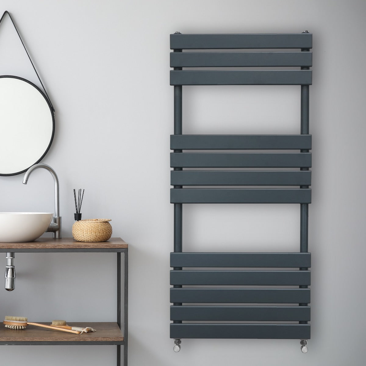 Sleek anthracite grey flat panel towel radiator with horizontal slats, mounted on a light wall in a modern bathroom setting