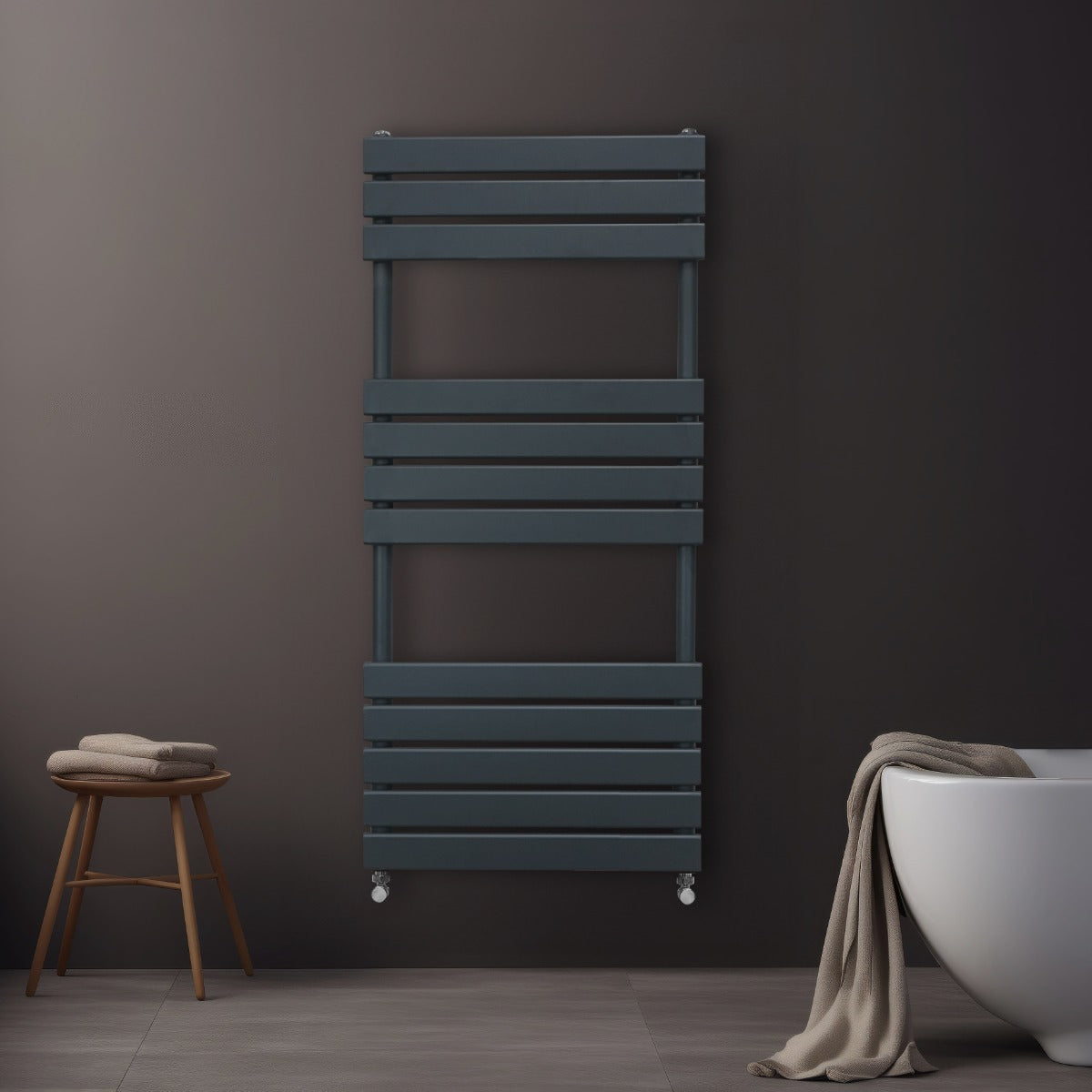 Sleek anthracite grey flat panel towel radiator mounted on a dark wall, featuring horizontal slats and a modern design, with a towel draped nearby