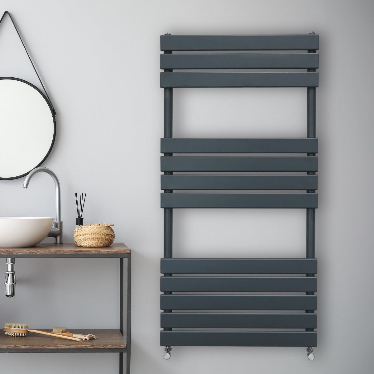 Anthracite grey flat panel towel radiator mounted on a wall, featuring sleek horizontal slats and a modern design, enhancing bathroom decor
