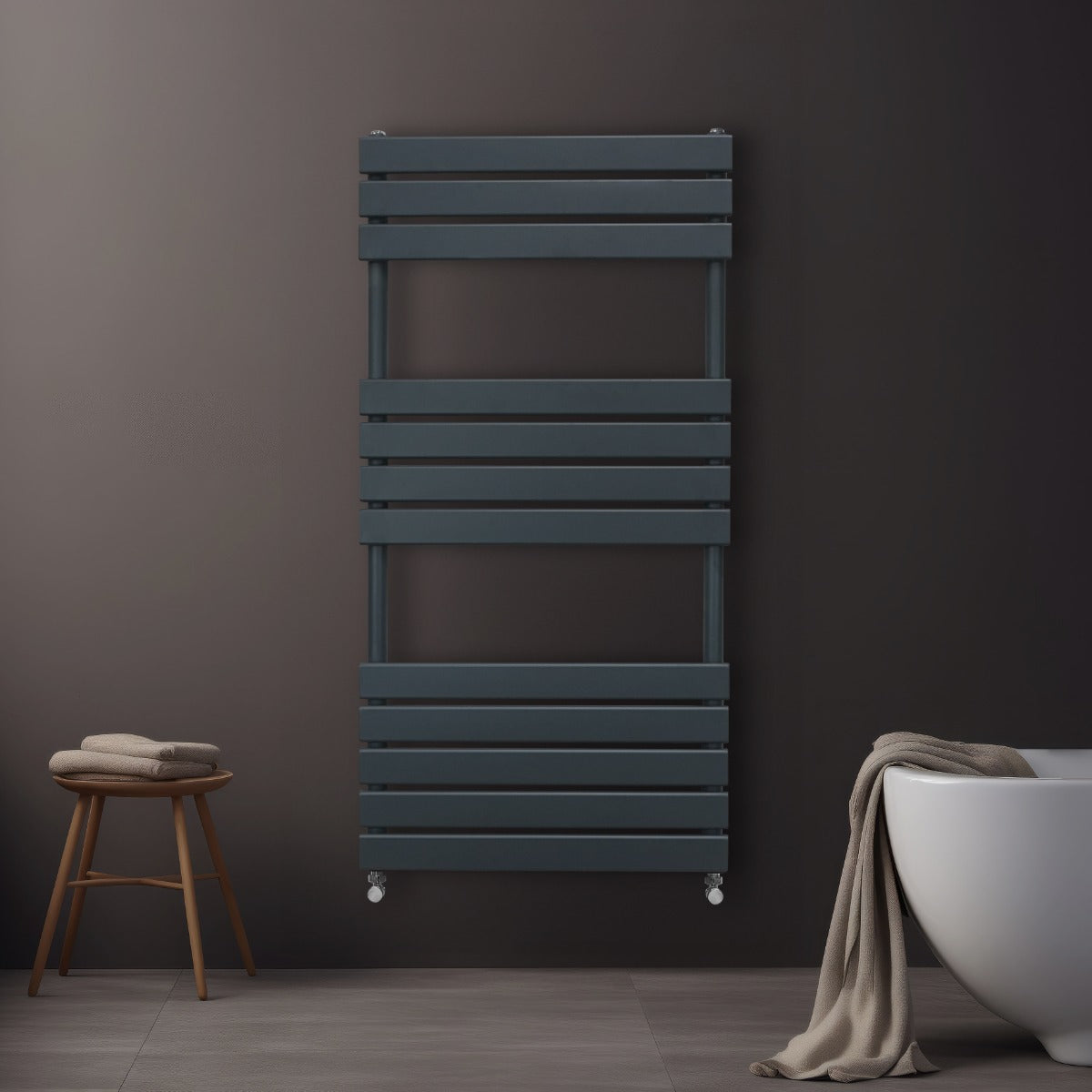 Sleek anthracite grey flat panel towel radiator mounted on a dark wall, featuring horizontal slats and a modern design, with a soft towel draped nearby