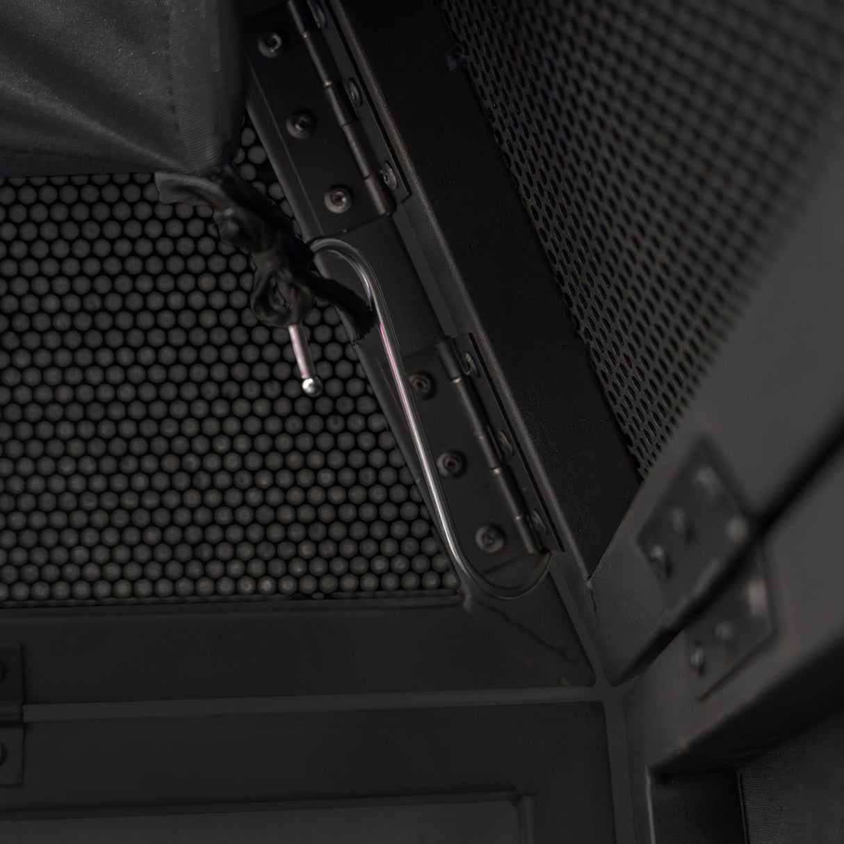 Close-up of the DJ Disco Booth Pro's sleek black metal frame, featuring a textured mesh backdrop and secure locking mechanism