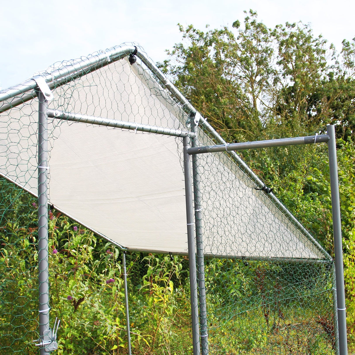 Durable chicken run featuring a sturdy metal frame, hexagonal wire mesh, and a protective canopy, ideal for outdoor poultry safety