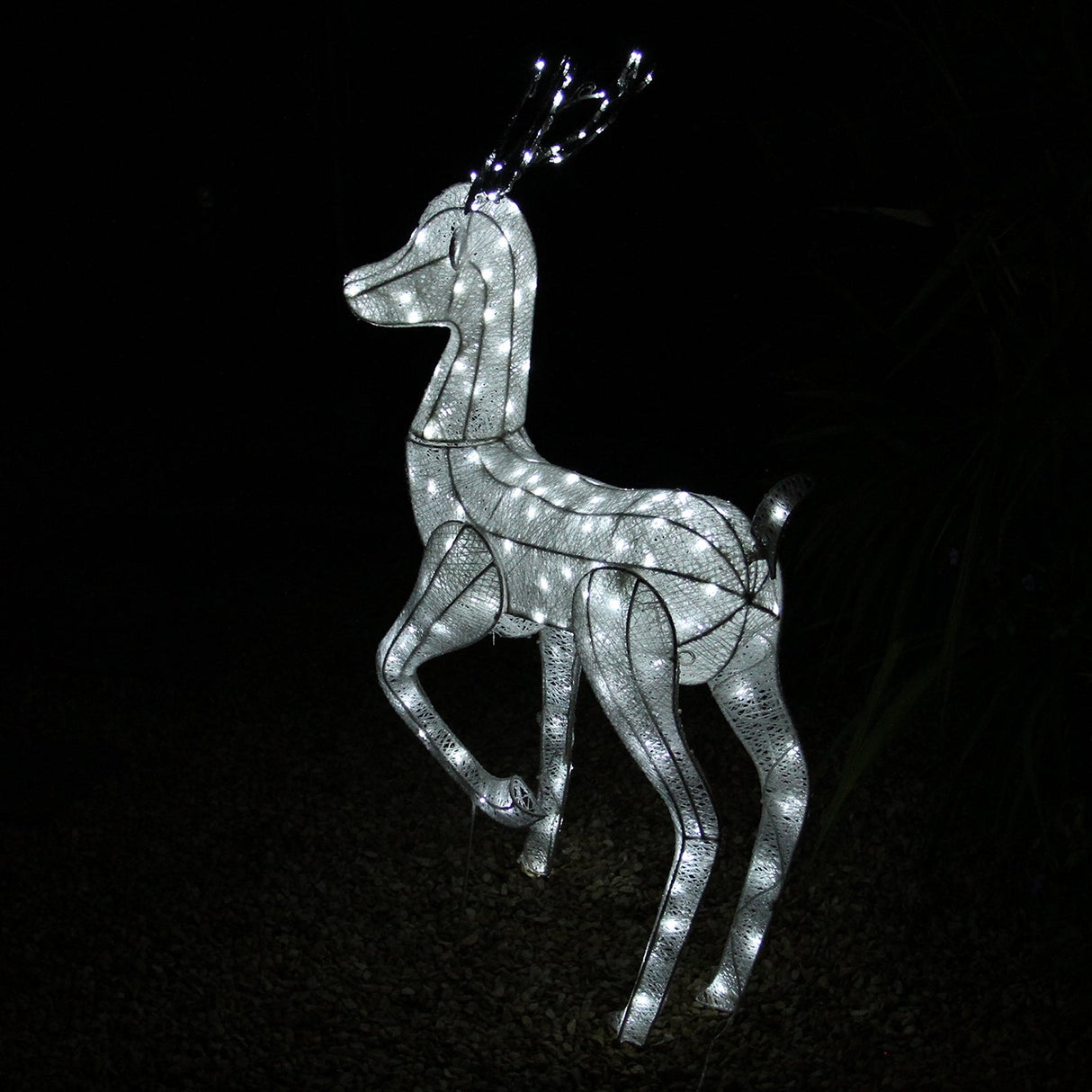 Large light-up stag reindeer with a sleek white frame, glowing with bright LED lights, set against a dark background
