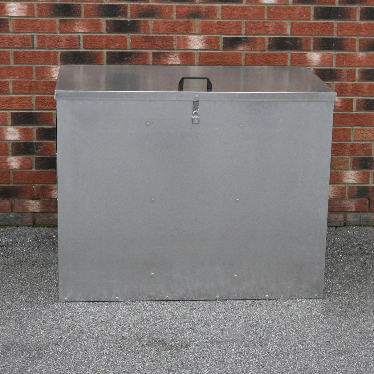 Galvanised steel feed store with three compartments, featuring a secure lid, sturdy handle, and a sleek metallic finish against a brick background