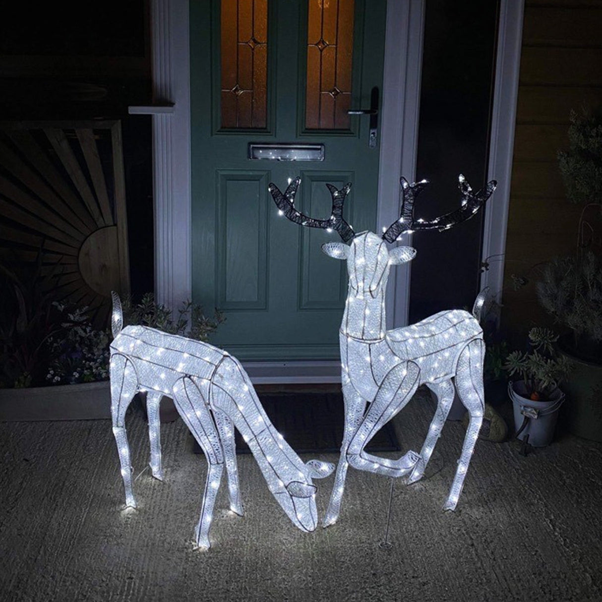 Glowing white stag and doe reindeer set with intricate wireframe design, perfect for festive outdoor holiday decor