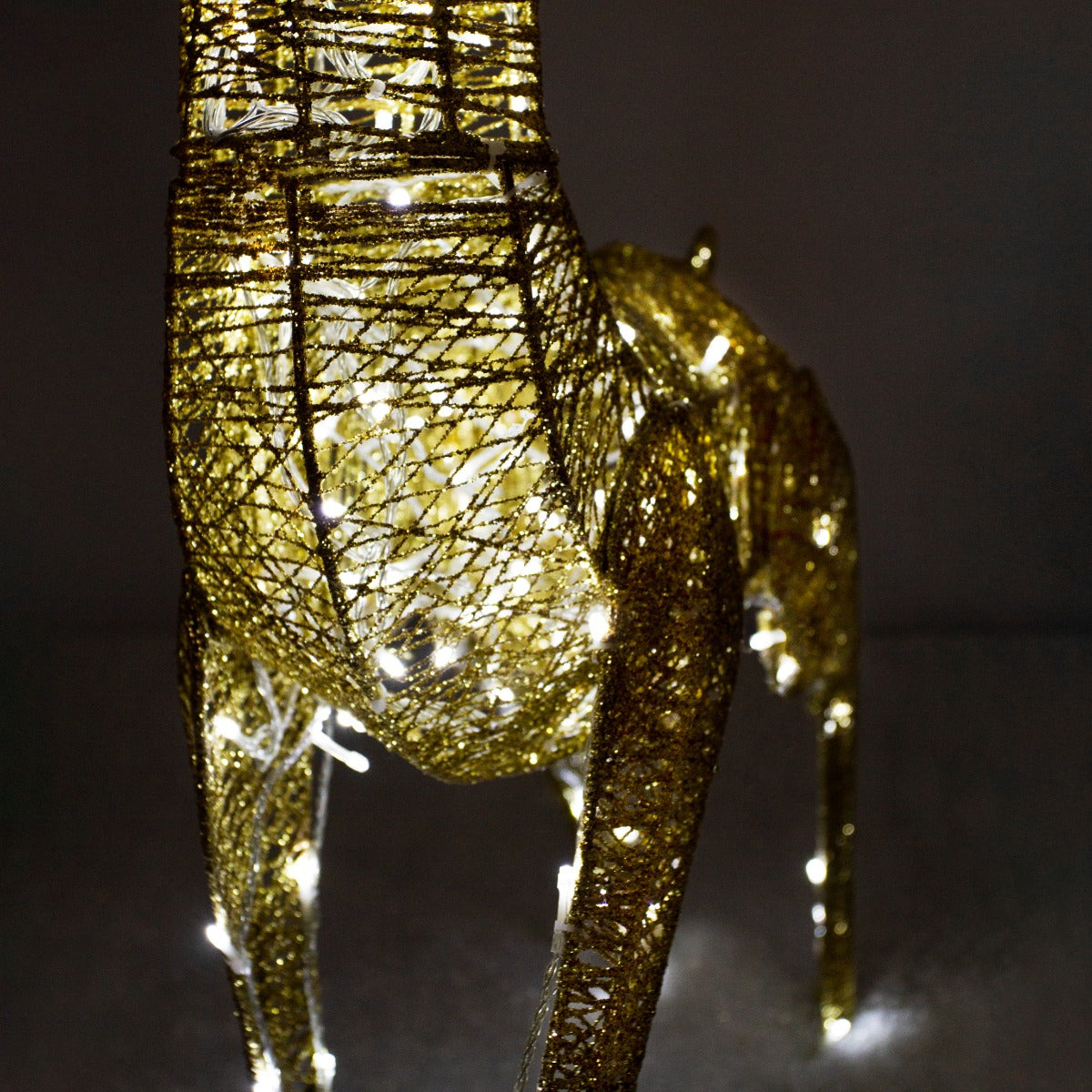 Gold stag reindeer sculpture adorned with 200 ice white LED lights, featuring intricate wire detailing and a shimmering finish