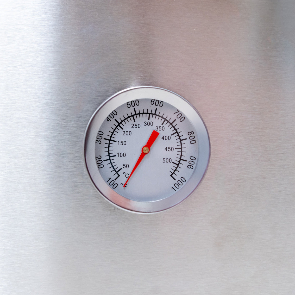Stainless steel thermometer with a clear dial, displaying temperatures up to 900°F, ideal for monitoring pizza oven heat levels