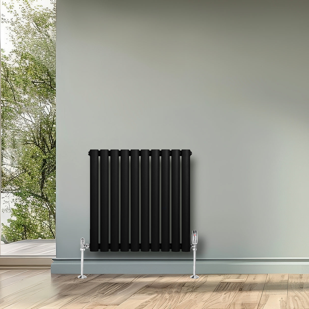Sleek black oval single column radiator mounted on a wall, complemented by chrome valves, enhancing modern interior decor