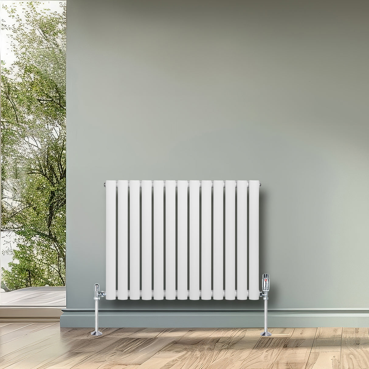 Sleek white oval single column radiator with chrome valves, positioned against a soft green wall, enhancing modern interior decor