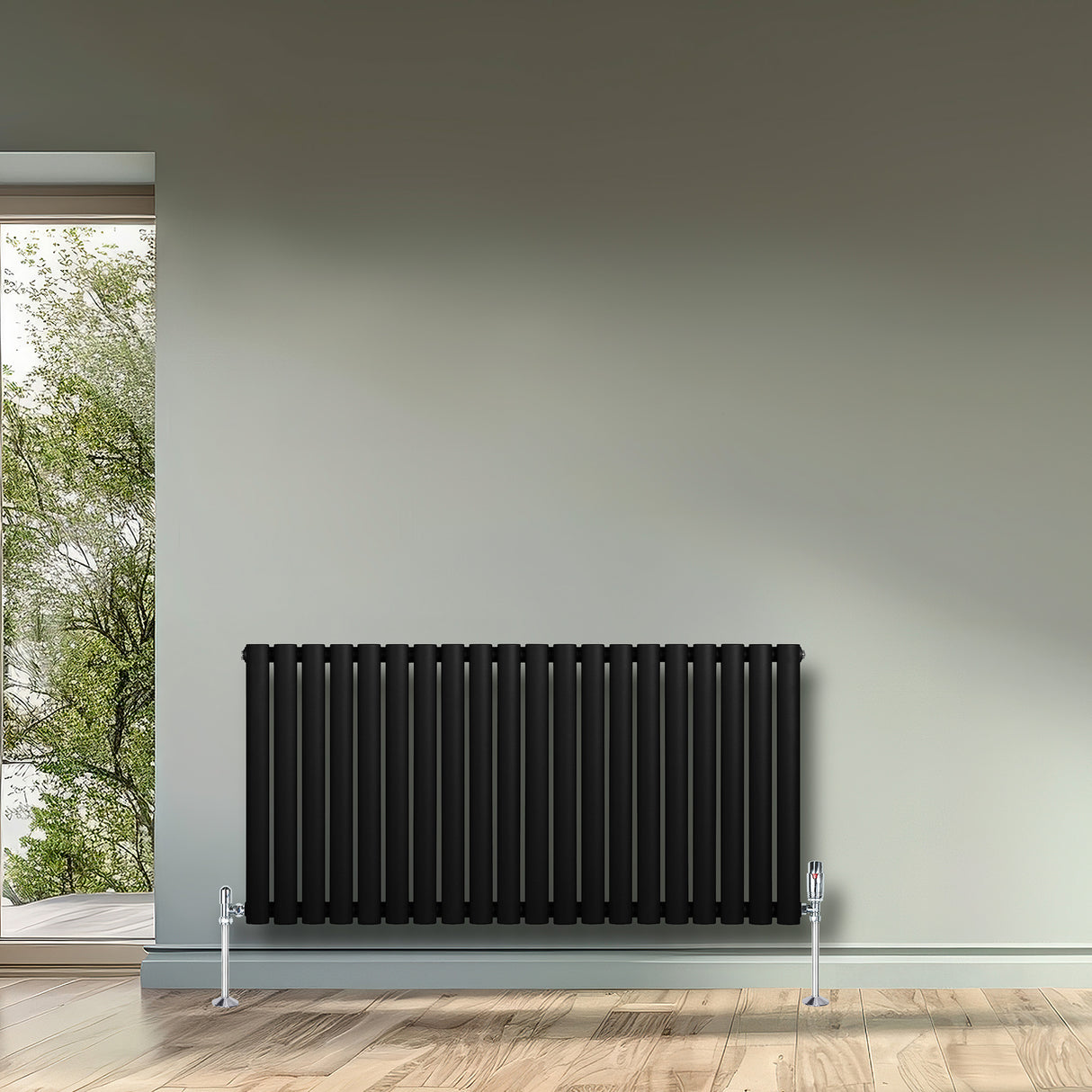Sleek black oval single column radiator with chrome valves, mounted on a light wall, complementing a modern interior design