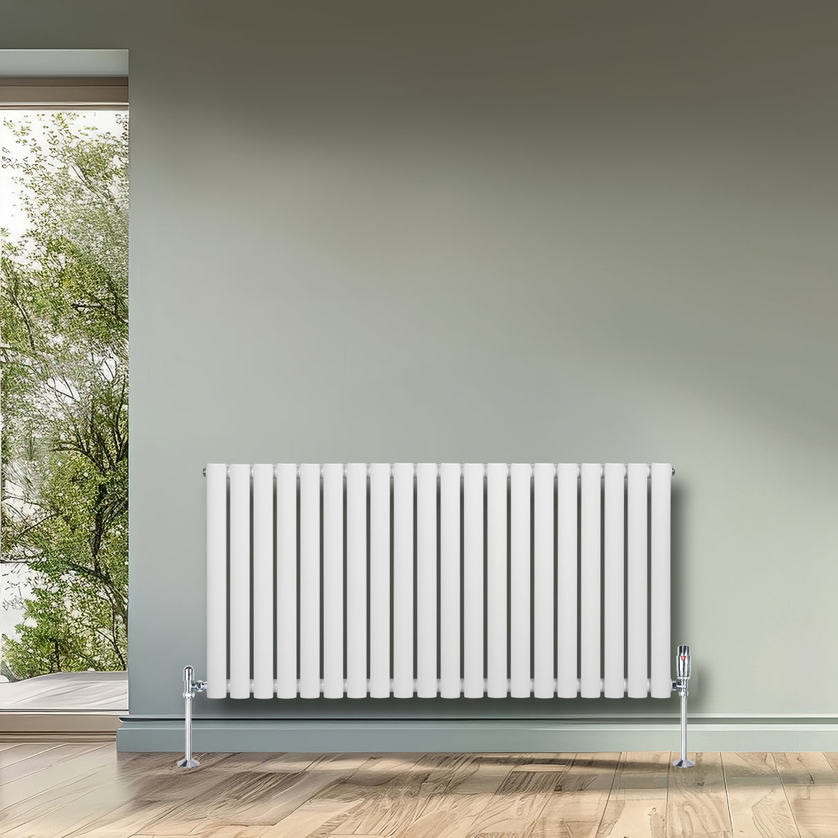 White oval single column radiator with chrome valves, positioned against a light green wall, enhancing modern interior decor