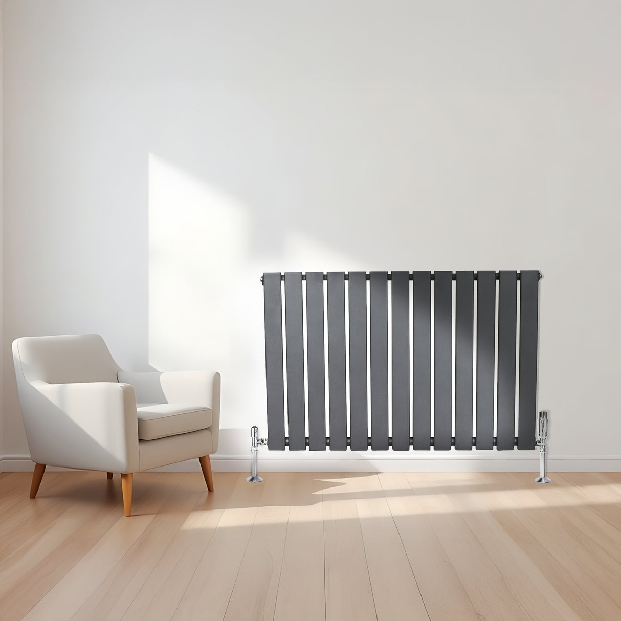 Flat single column radiator in anthracite grey, featuring sleek vertical lines and chrome valves, positioned beside a modern armchair