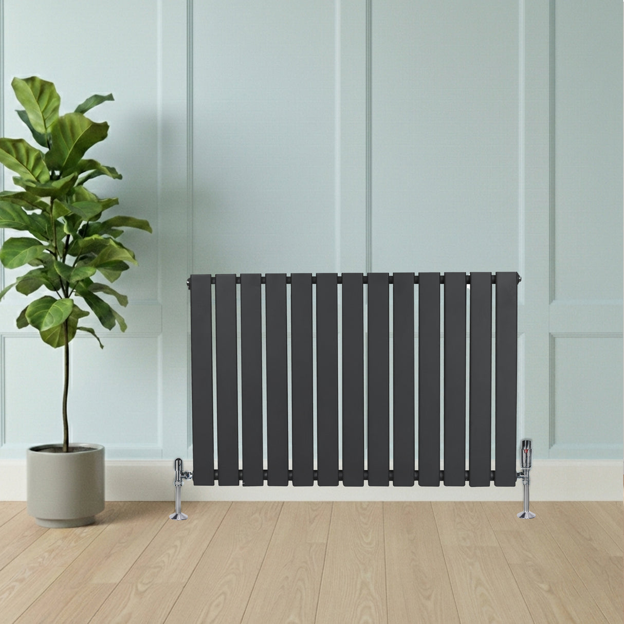 Flat single column radiator in anthracite grey, featuring sleek vertical slats, positioned beside a potted plant on wooden flooring