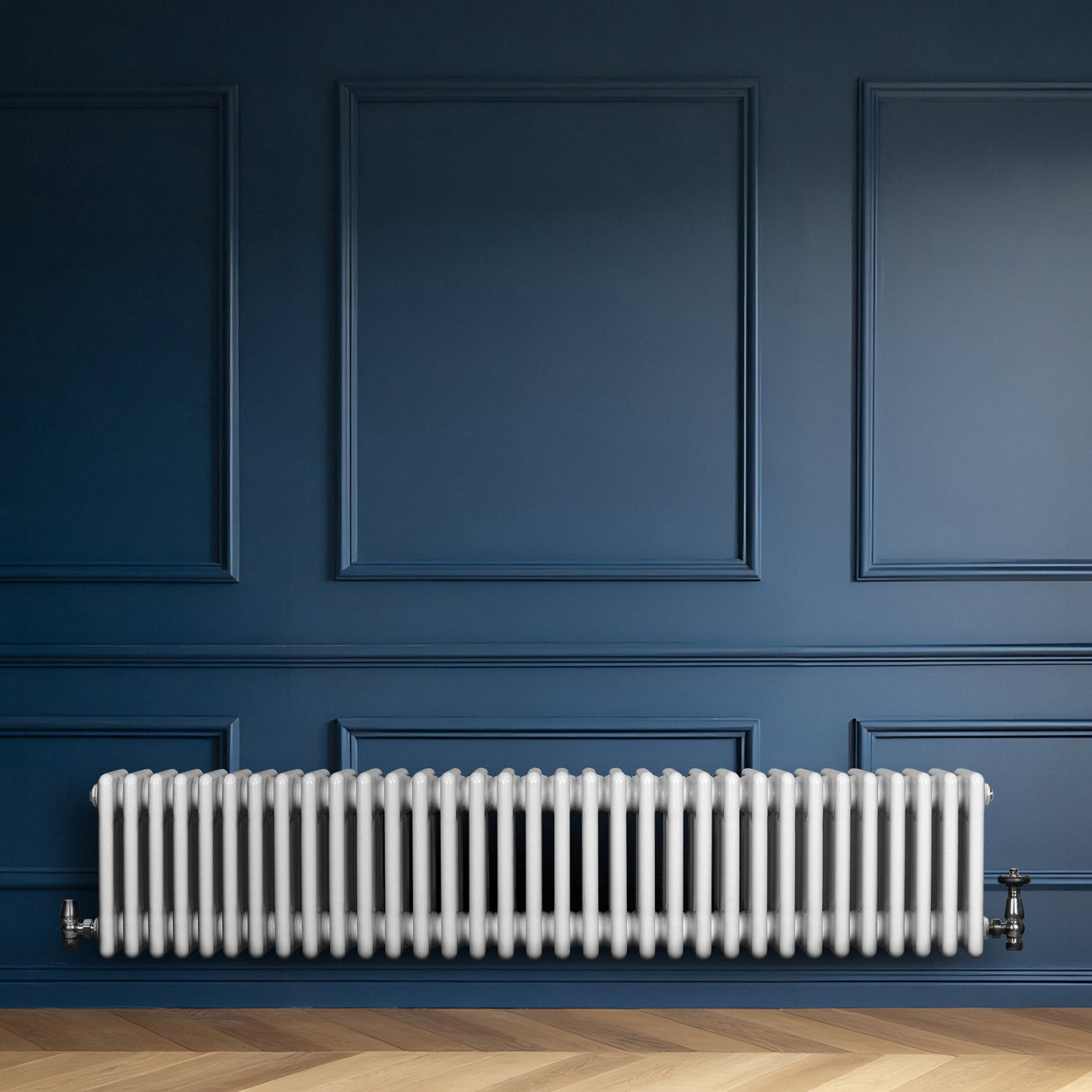 Traditional white 4 column radiator with smooth, rounded edges, positioned against a deep blue wall, enhancing modern decor