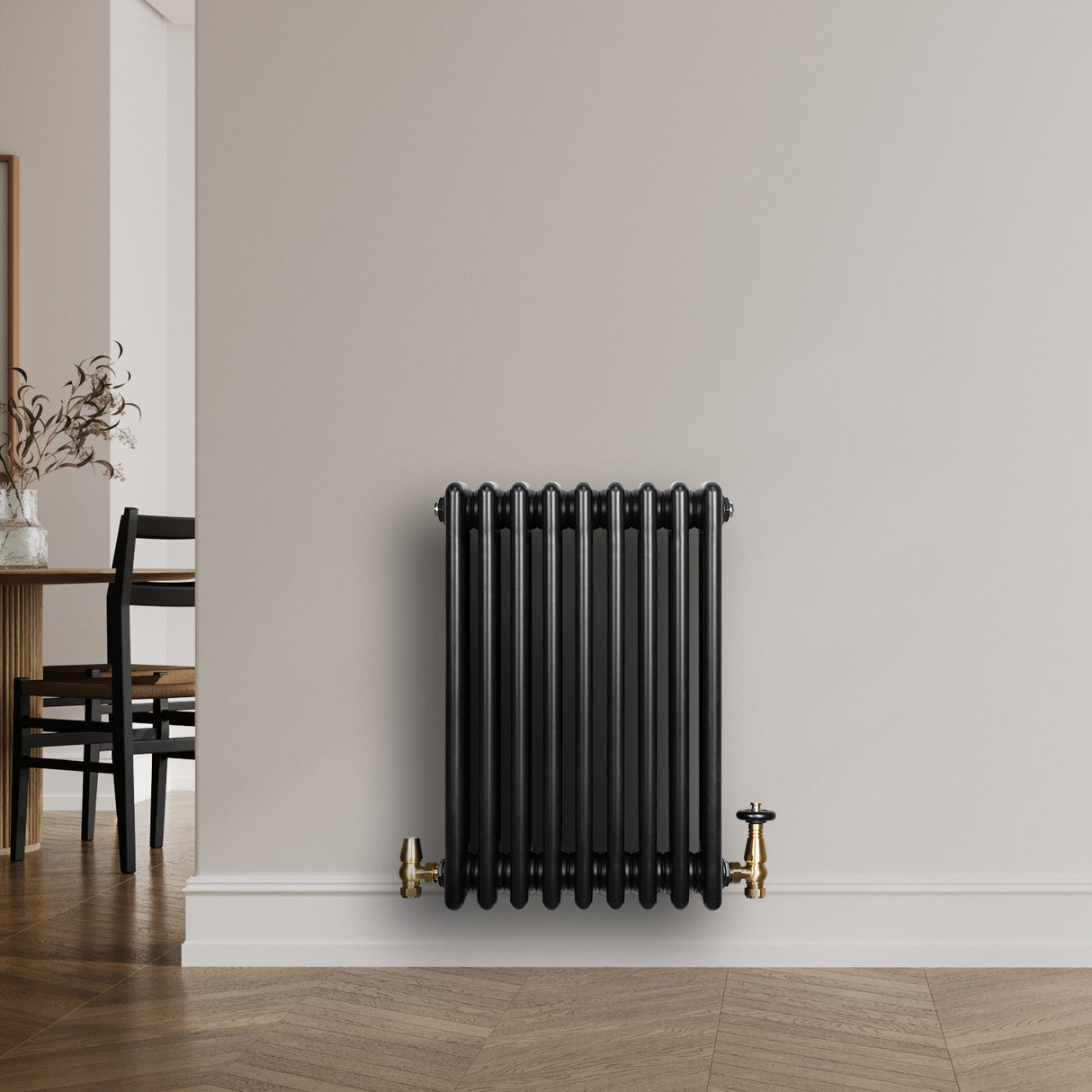 Traditional black 4 column radiator with brass valves, featuring a sleek design and smooth, glossy finish, perfect for modern interiors