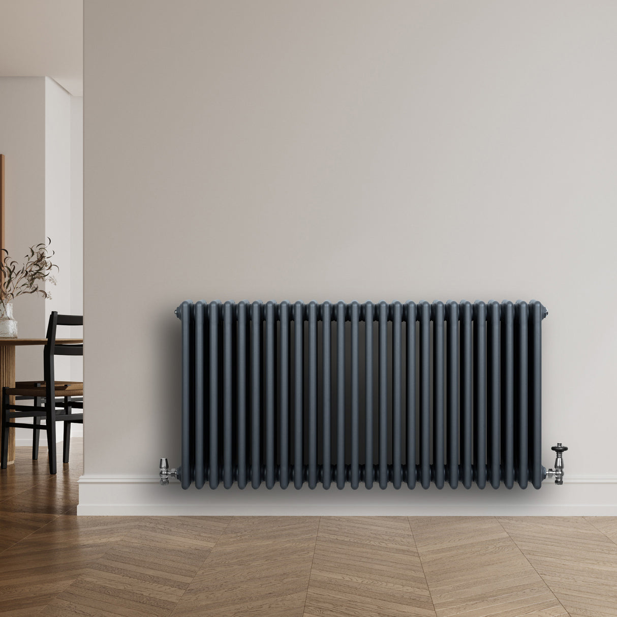 Traditional anthracite grey 4 column radiator with sleek vertical lines, mounted on a light wall, enhancing modern interior decor