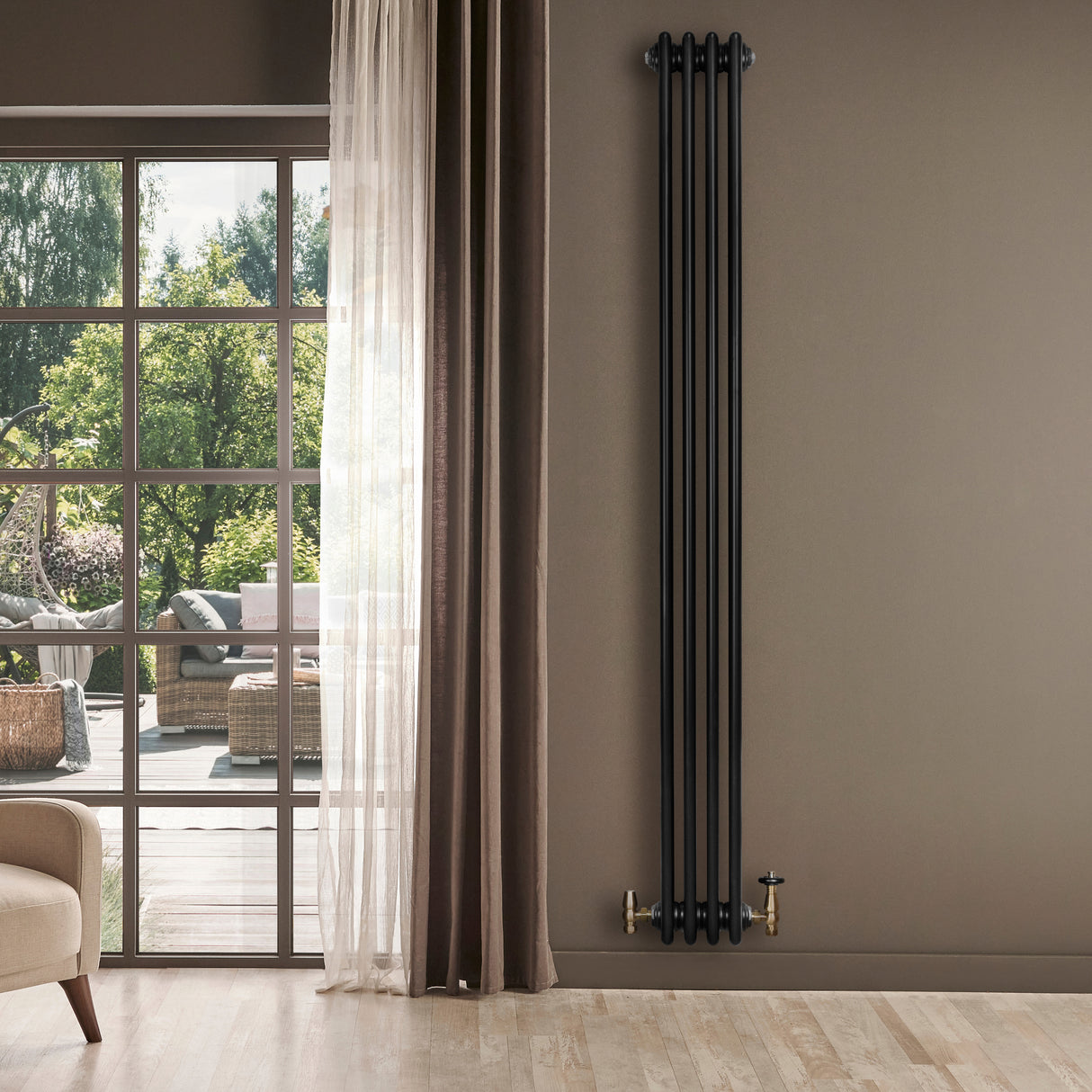 Sleek black traditional 4 column radiator with brass valves, mounted on a wall beside a large window, enhancing modern decor