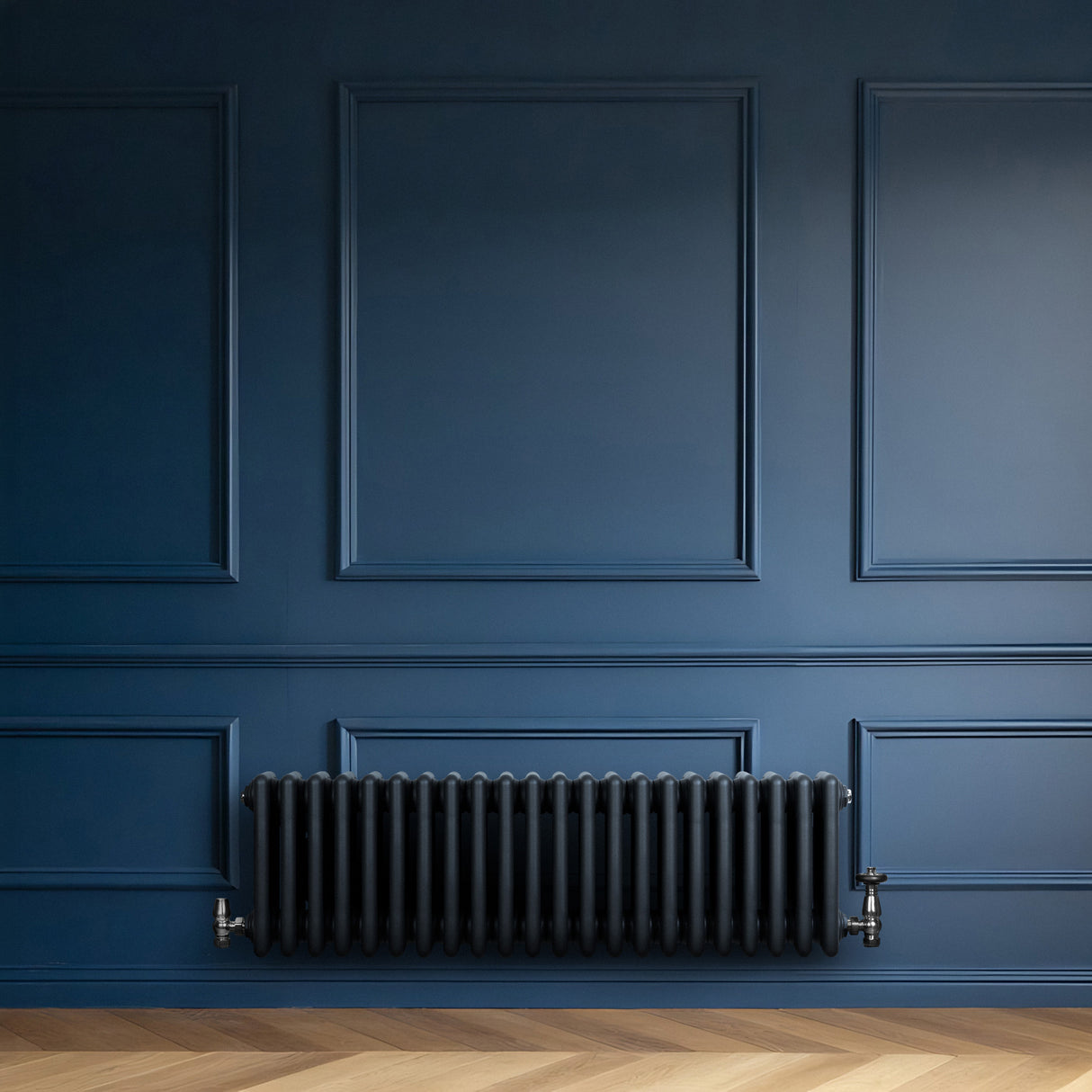 Traditional anthracite 4 column radiator against a deep blue wall, featuring a sleek, modern design and smooth, glossy finish
