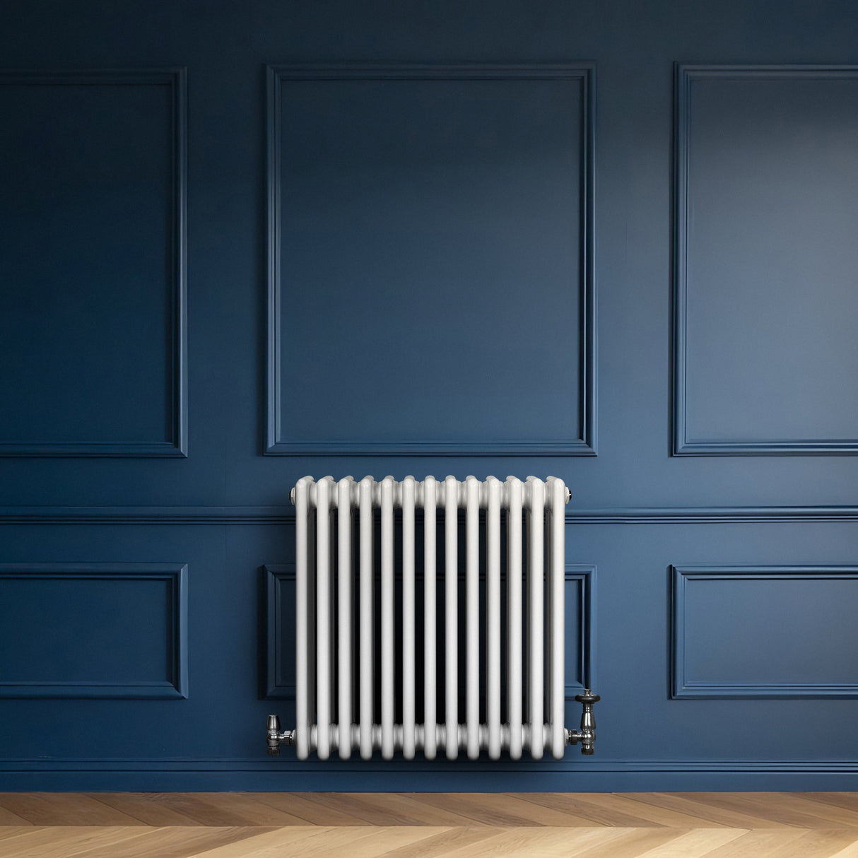 Traditional white 4 column radiator against a deep blue wall, featuring smooth, glossy finish and sleek, vertical lines