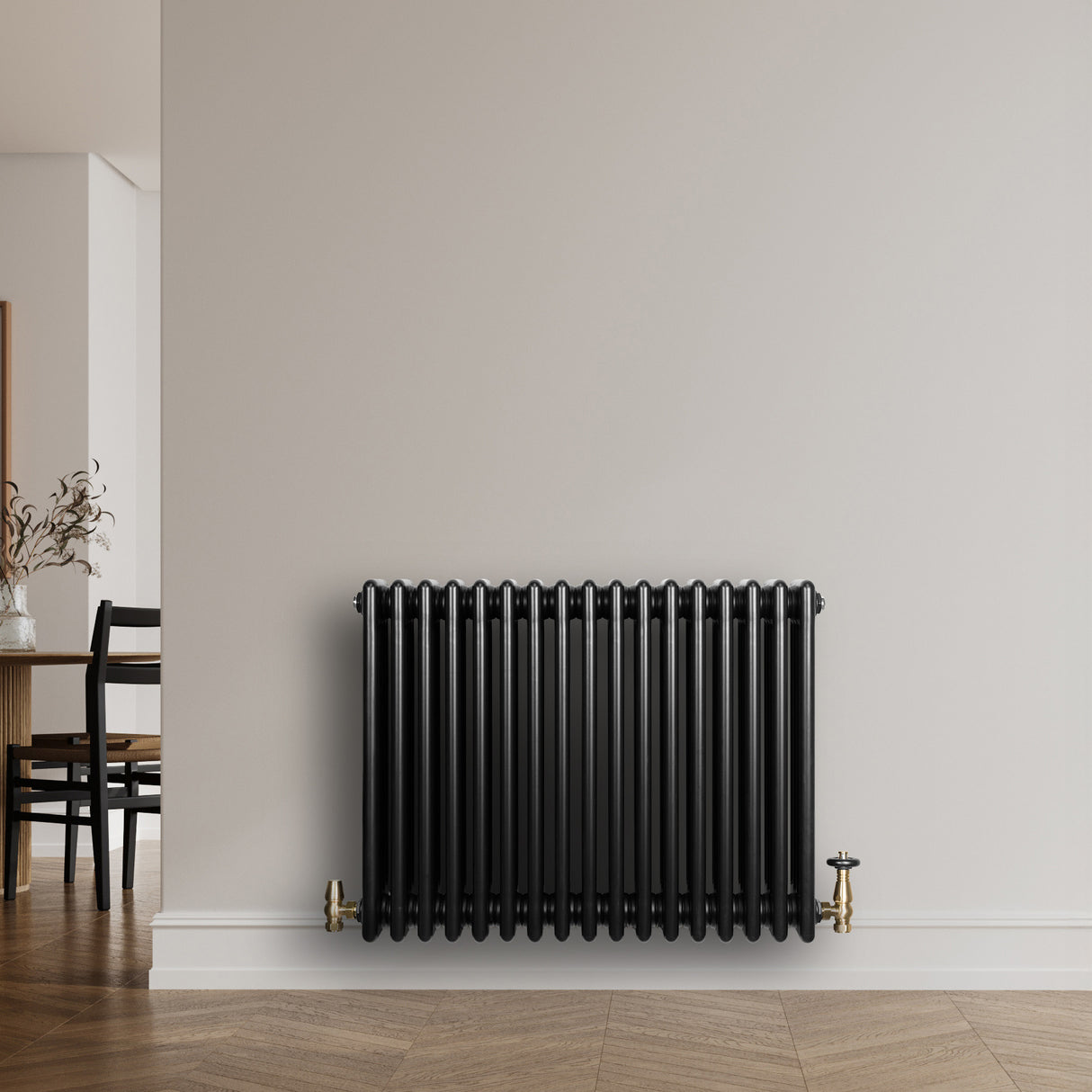 Traditional black 4 column radiator with a sleek finish, mounted on a light wall, enhancing modern interior decor