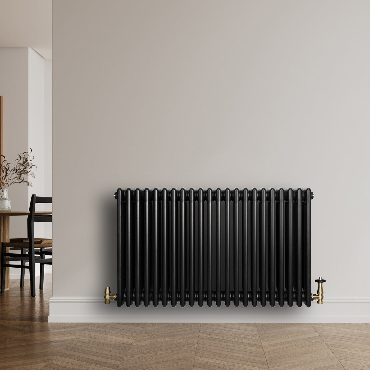 Traditional black 4 column radiator, 600 x 1010mm, featuring a sleek, glossy finish and brass fittings, mounted on a light wall