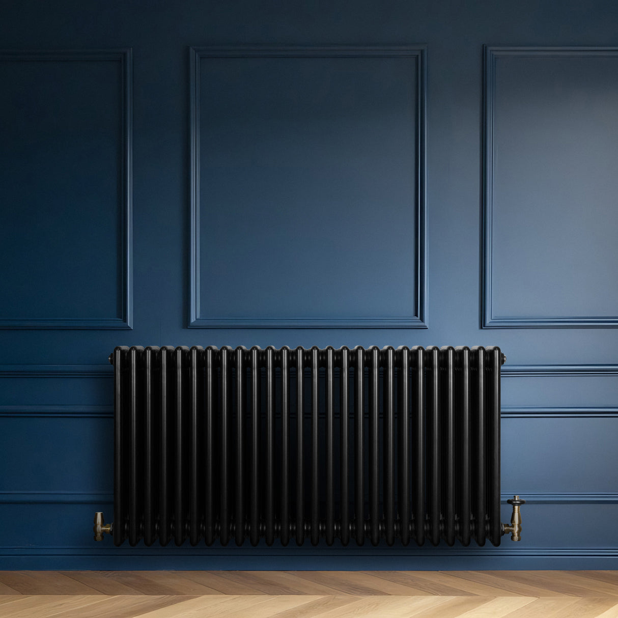 Traditional black 4 column radiator against a deep blue wall, featuring sleek lines and a glossy finish, enhancing modern decor