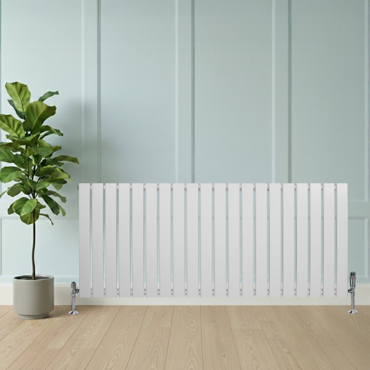 Sleek white flat single column radiator, 600 x 1400mm, with vertical slats and chrome feet, beside a potted plant on wooden floor