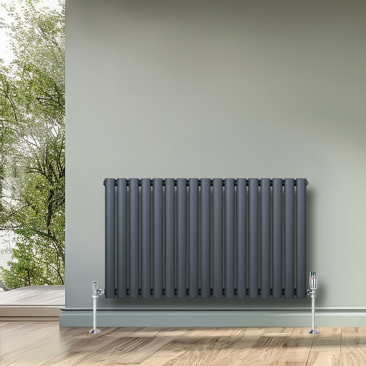 Anthracite grey oval single column radiator with vertical fins, mounted on a wall, complementing a modern interior setting