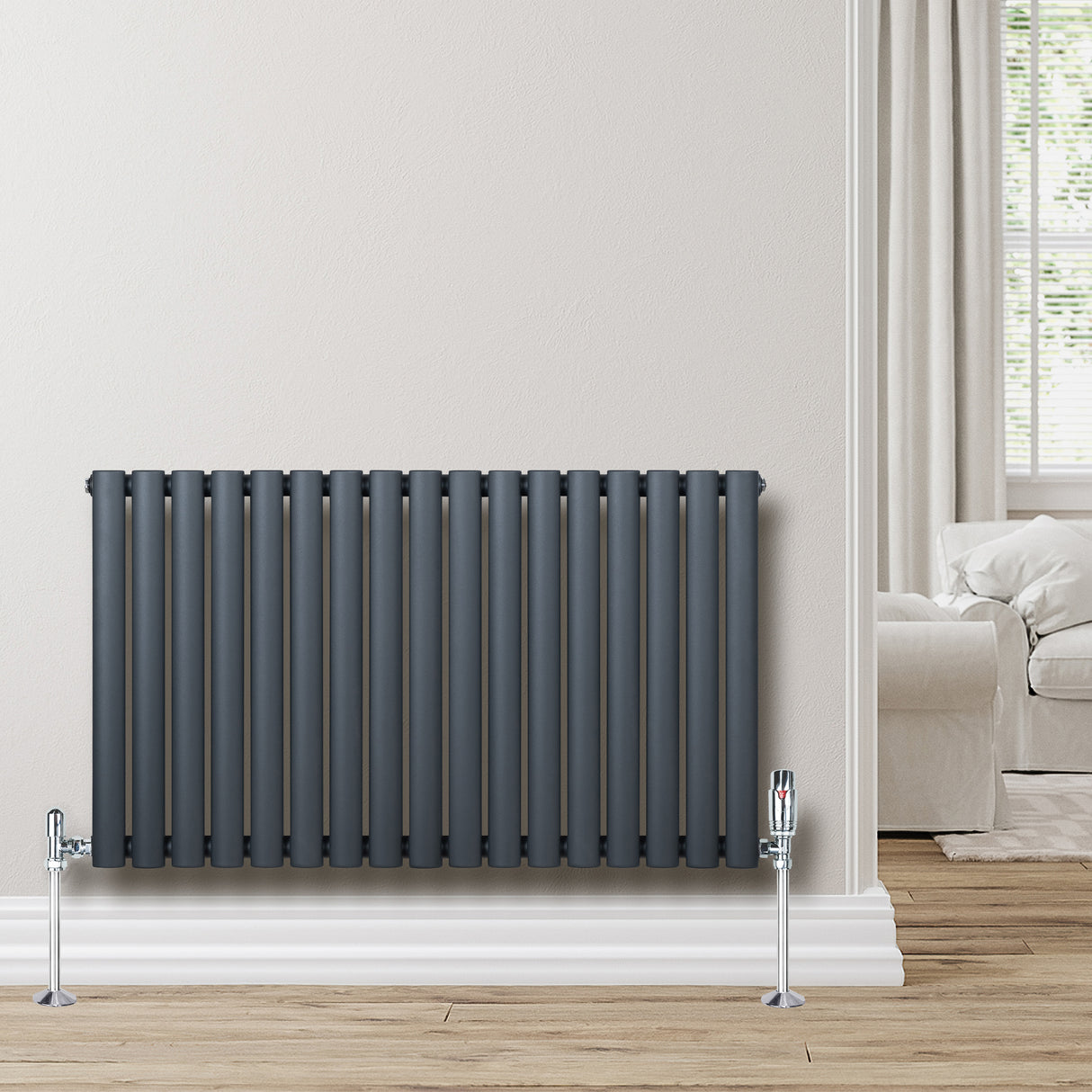 Anthracite grey oval single column radiator, 600 x 1020mm, with sleek vertical bars and chrome valves, mounted against a light wall