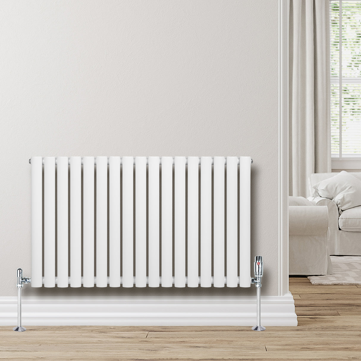 Sleek white oval single column radiator, 600 x 1020mm, mounted on a light-colored wall, complementing a cozy living room setting