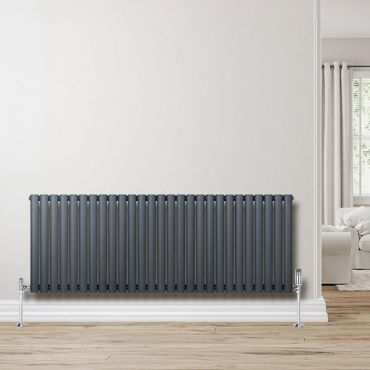 Anthracite grey oval single column radiator, 600 x 1620mm, featuring sleek vertical lines and a modern finish against a light wall