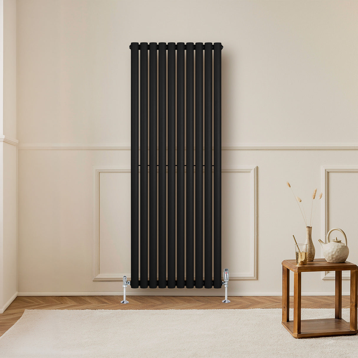 Sleek black oval single column radiator, 1600 x 600mm, mounted on a wall, complementing a modern room with wooden accents
