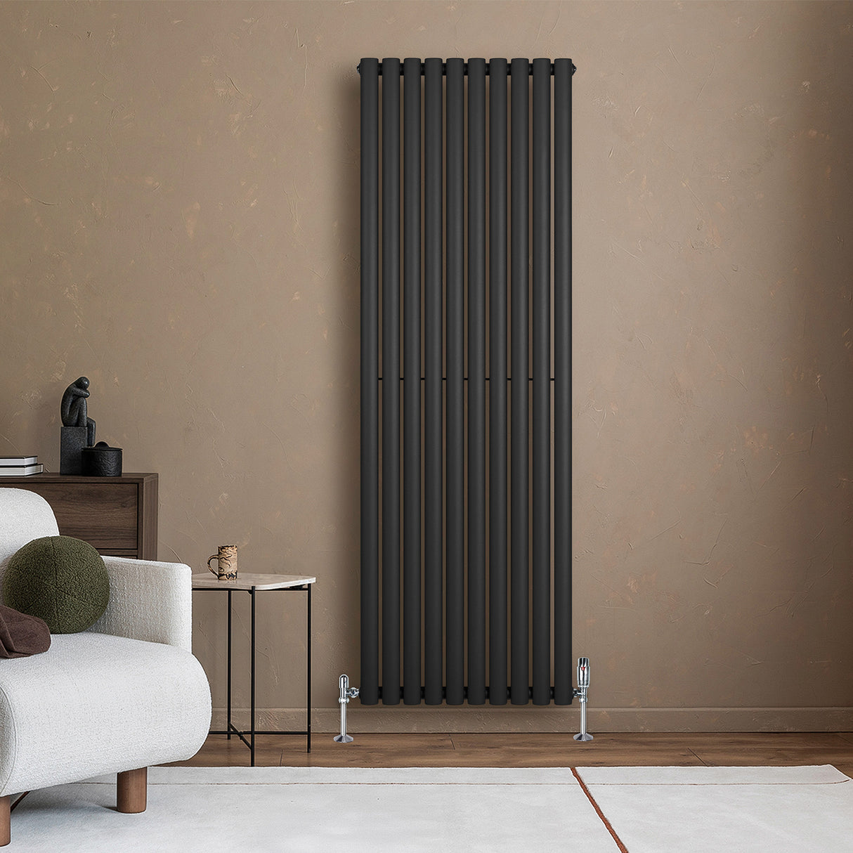 Sleek black oval single column radiator mounted on a textured beige wall, complementing modern living room decor with a minimalist design