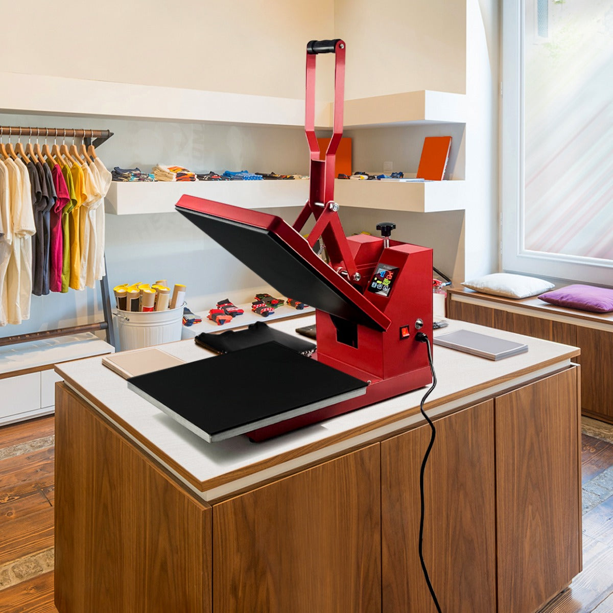 Bright red PixMax 38cm clam heat press with a large black heating plate, positioned on a wooden table in a well-lit store setting