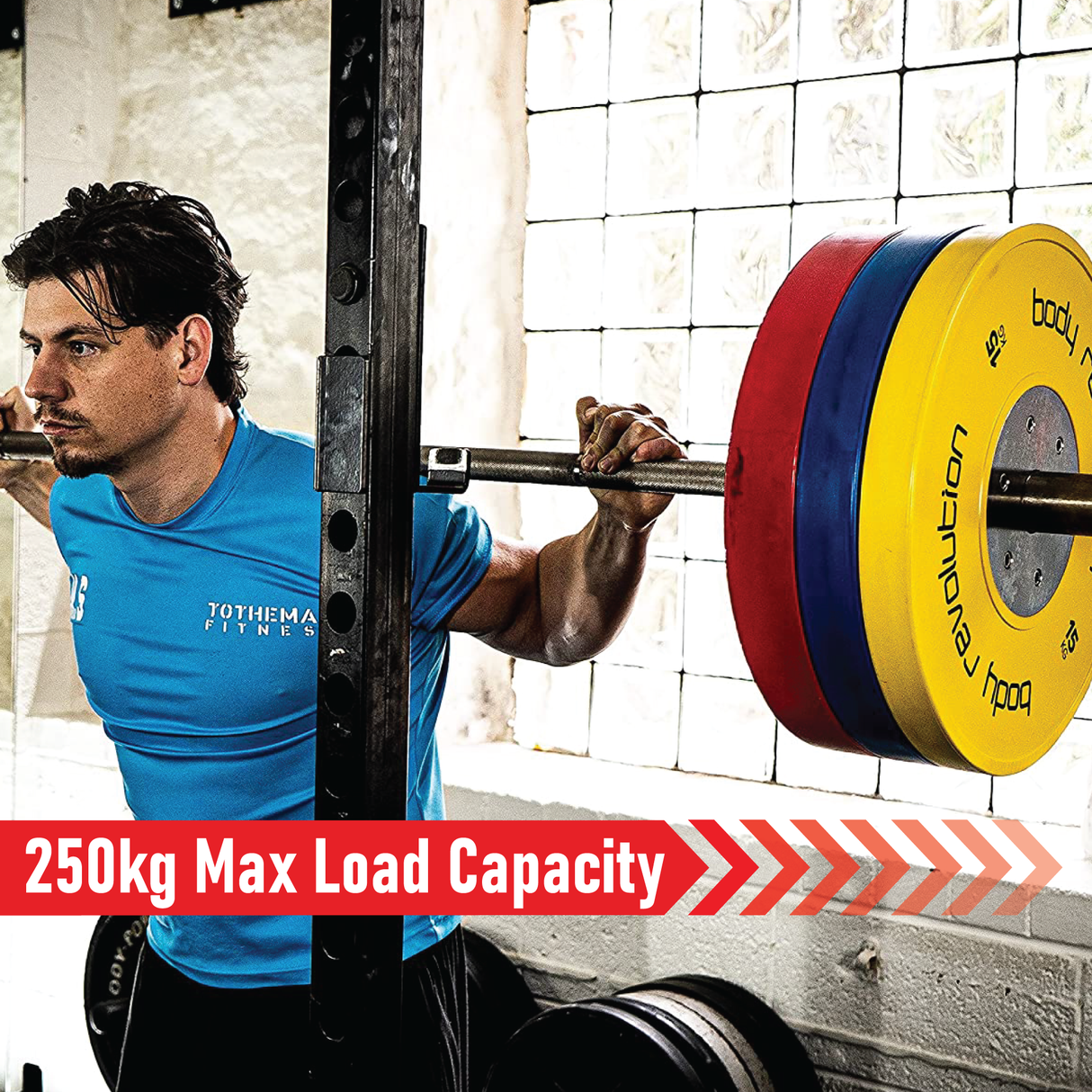 A man lifting a 4ft Olympic barbell with colorful weight plates, showcasing a strong grip and focused expression in a gym setting