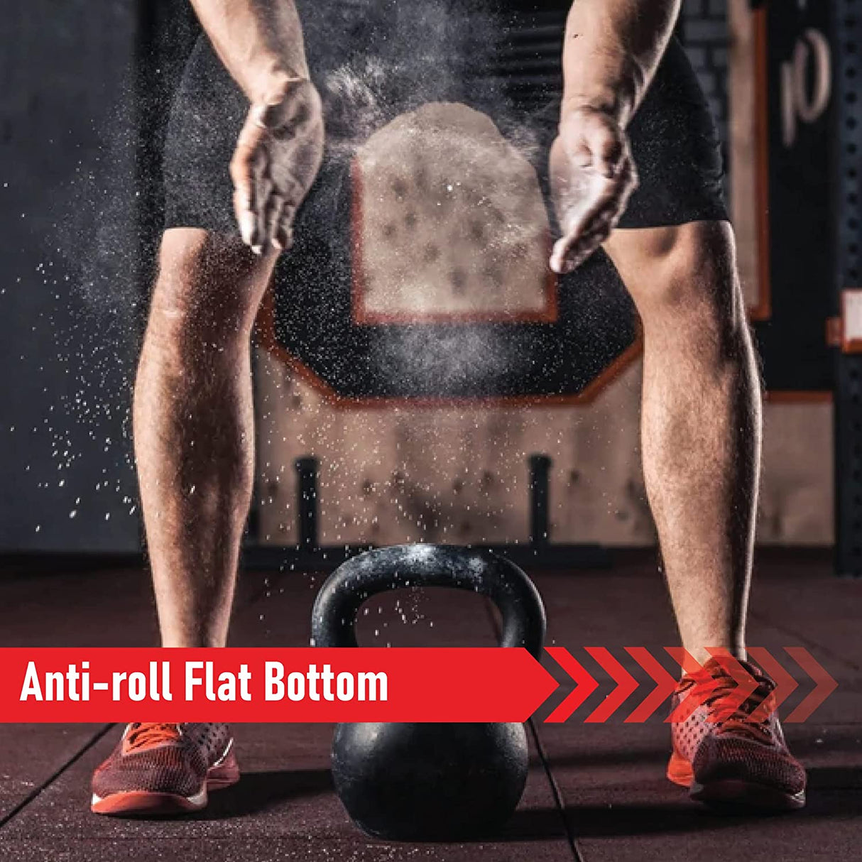Black cast iron kettlebell with anti-roll flat bottom, positioned on gym floor, surrounded by dust and a focused athlete in workout attire