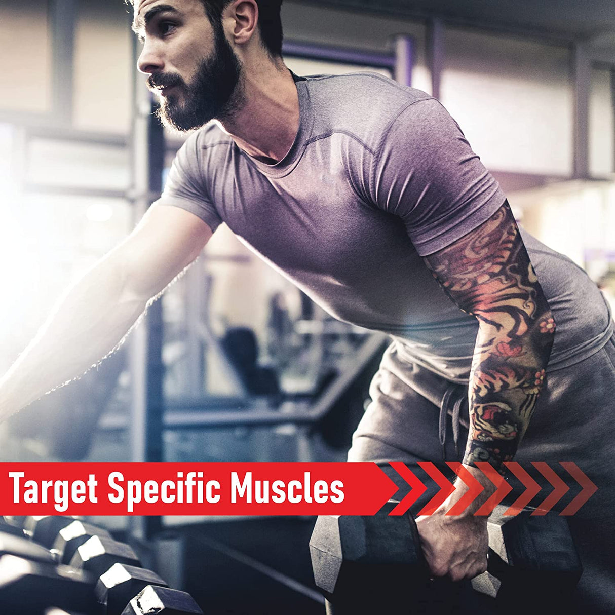 Man with a tattoo lifting a hex dumbbell in a gym, showcasing strength training with focus on targeted muscle groups