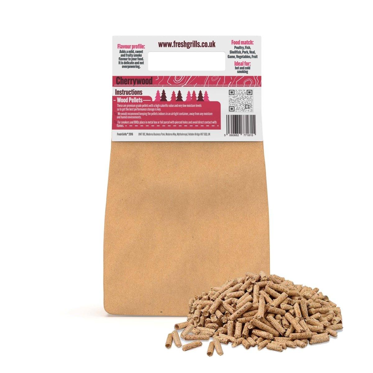 Cherrywood BBQ grill pellets in a brown paper bag, with a pile of small, cylindrical wood pellets in the foreground