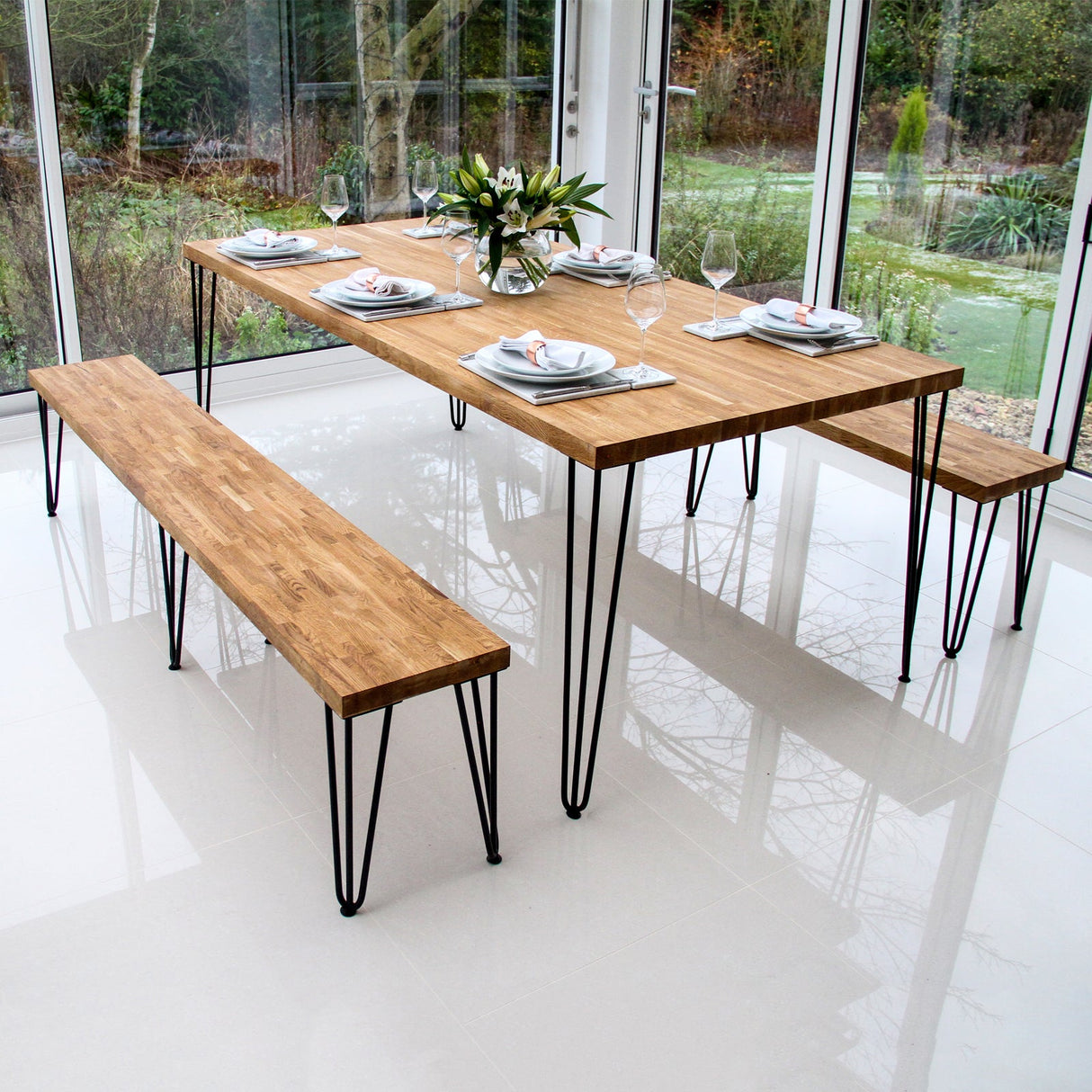 Black 12mm hairpin legs supporting a modern wooden dining table and benches, showcasing sleek lines and a minimalist design
