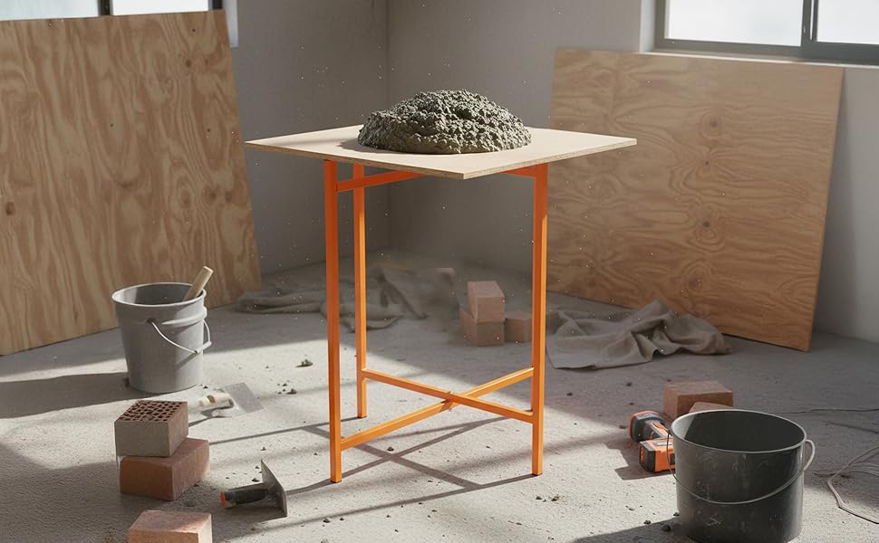 Mortar board stand with a textured concrete mix on a wooden surface, surrounded by construction materials and tools in a bright workspace