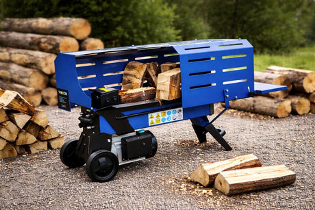 Bright blue log splitter positioned on gravel, surrounded by neatly stacked logs, showcasing its sturdy design and safety features