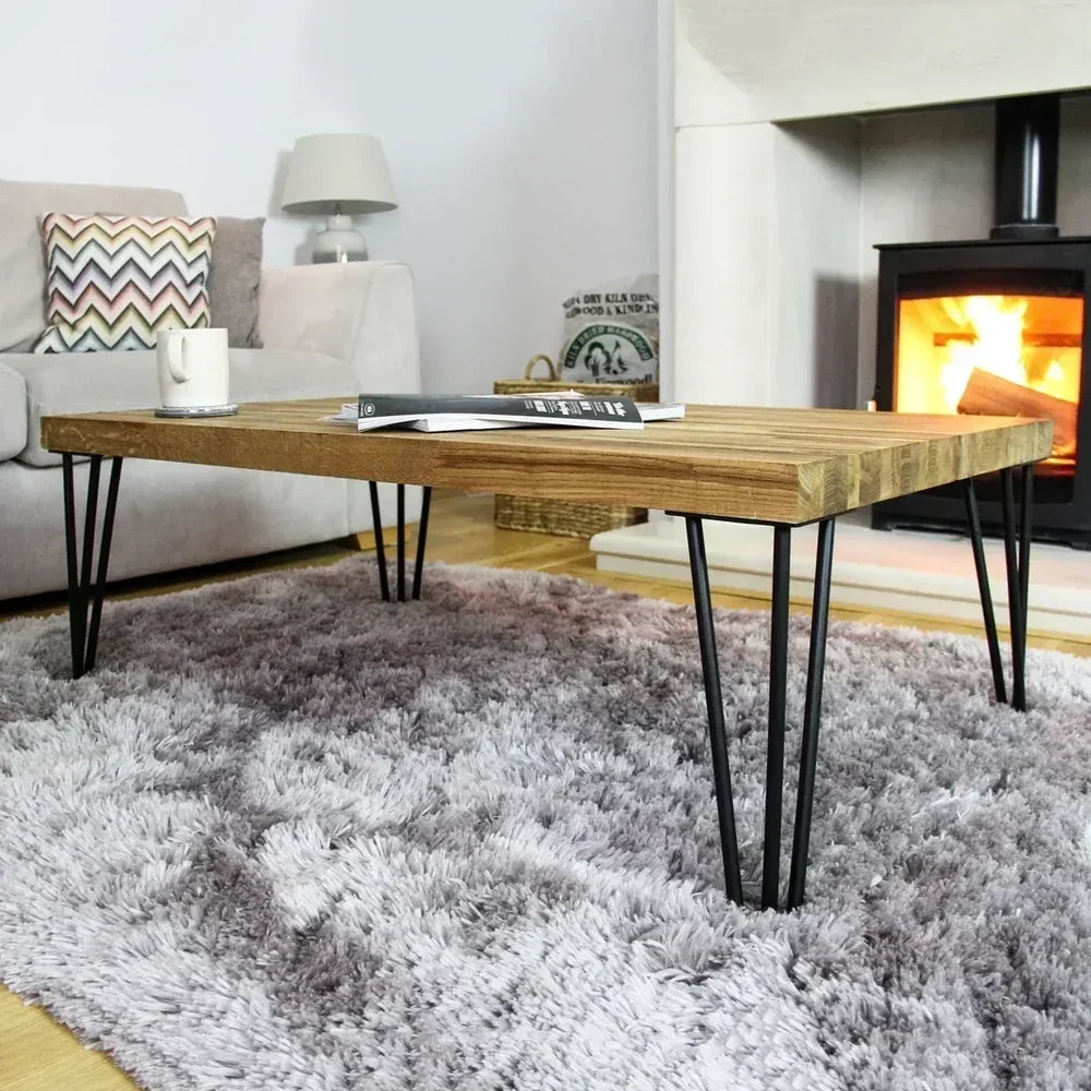 Stylish wooden coffee table with hairpin legs, set on a plush gray rug, near a cozy fireplace, enhancing modern decor