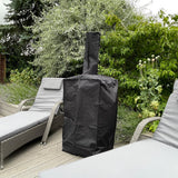 Durable black rain cover for Kukoo outdoor pizza oven, fitted snugly over the oven, placed beside lounge chairs in a garden setting