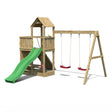 Wooden playset featuring a green slide, two red swings, and a fort-like structure with a peaked roof and ladder for climbing