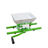 Green fruit crusher with a large aluminum hopper, sturdy metal frame, and a manual crank for efficient fruit processing