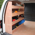Wooden van rack with multiple shelves, organized tools, and equipment, featuring a smooth finish and sturdy construction in a spacious cargo area