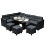 Stylish black rattan corner set featuring plush gray cushions, a glass tabletop, and matching ottomans, perfect for outdoor dining